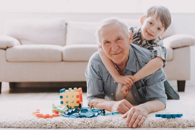 grandfather and grandson playing in the living room